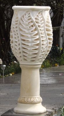 A Taste of Elegance
This is one of the most time consuming pieces I have ever carved! It took months - to carve out the bowl of the glass, drill thousands of holes to make the laceyness, shape the leaves, and the sanding was a nightmare.
But this piece while formal, is super elegant. I uplight it at night to show the shadows and form. Its one of my current favourites.  
