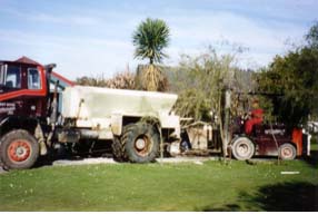 A truck helping recover the forklift from the driveway
